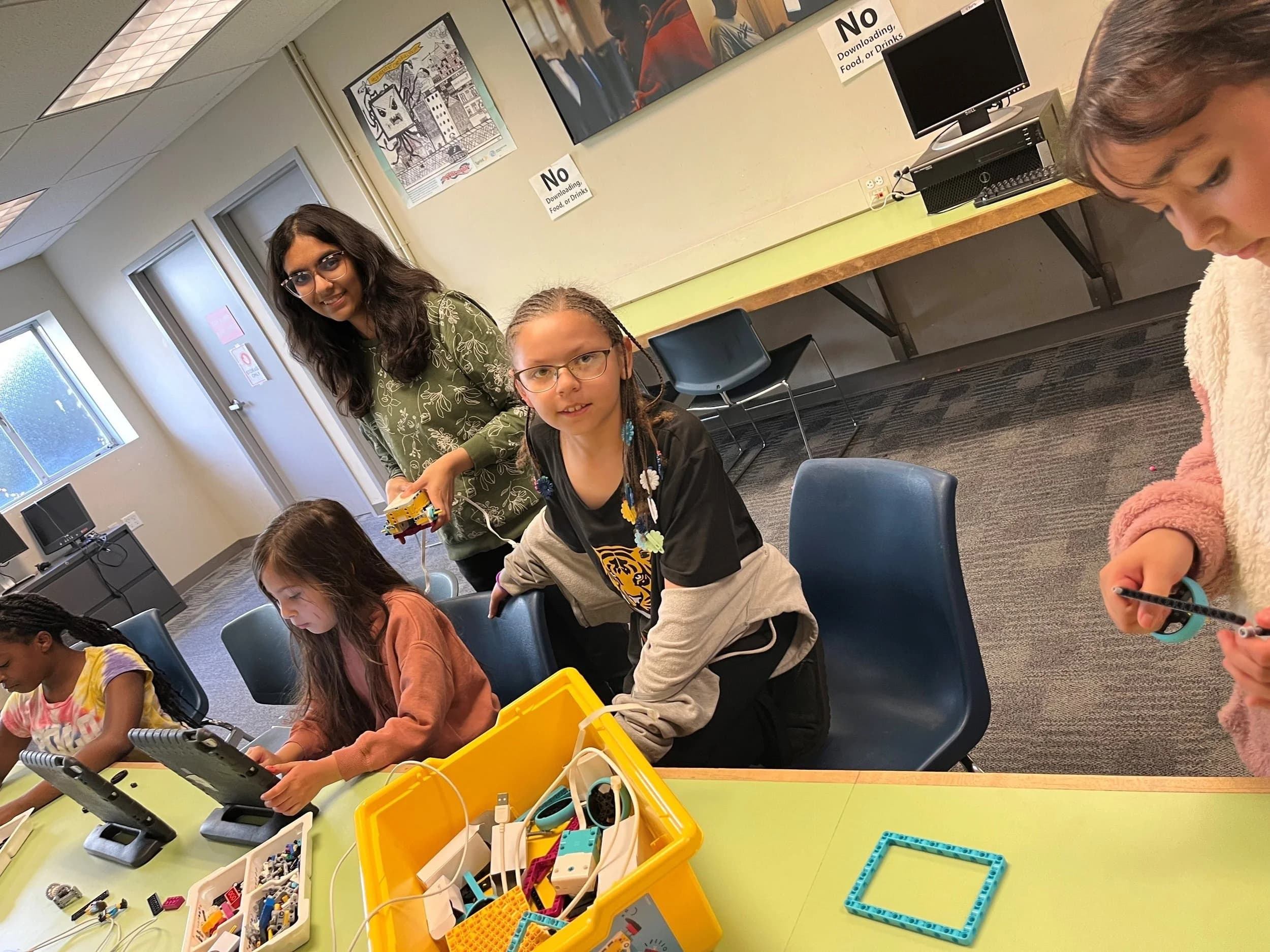 Youth engaged in robotics and coding activities