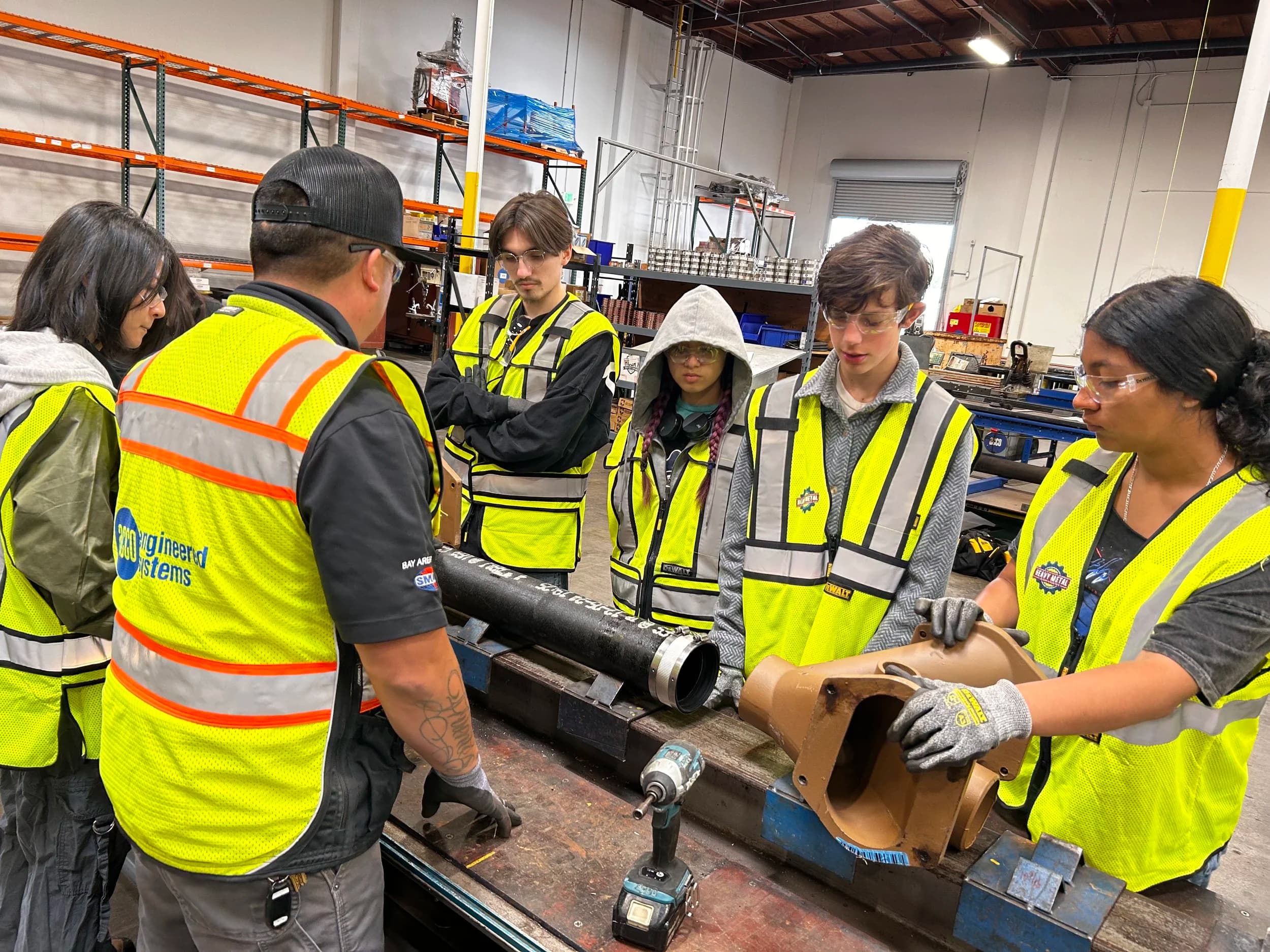 Teens working on plumbing project during Heavy Metal Summer Experience